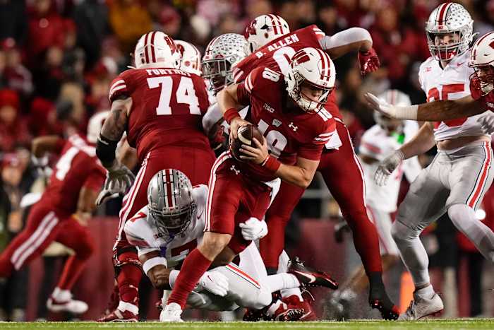 Oct 28, 2023; Madison, Wisconsin, USA; Ohio State Buckeyes cornerback Jordan Hancock (7) pressures Wisconsin Badgers quarterback Braedyn Locke (18) during the first half of the NCAA football game at Camp Randall Stadium.
